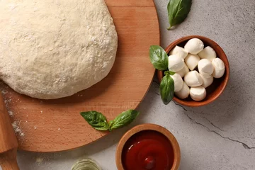 Fotobehang Pizza dough, products and rolling pin on gray textured table, flat lay © New Africa