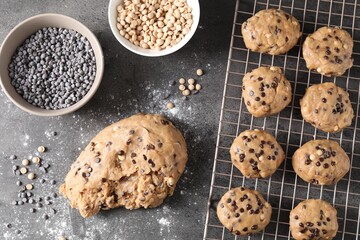 Raw dough with chocolate chips on grey table, flat lay
