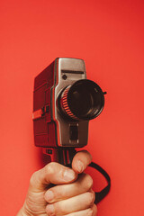 vintage portable movie camera in the operator's hand. retro, 70s, 80s
