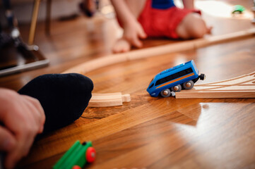 A child's playful moment captured as a blue toy train derailed and fell due to a broken road over...