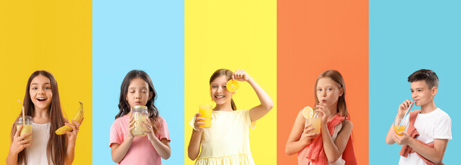 Group of little children with healthy fruit juices on color background