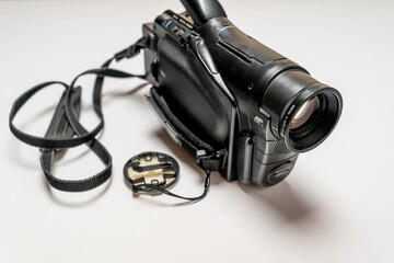 Vintage analog VHS video camera on a white background. The 90s