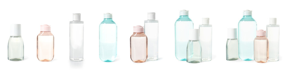 Set of many bottles of micellar water on white background