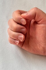 A man's hand with long uncut damaged nails. Unkempt nails of a man on a white background. Close-up