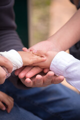 Family members holding hands together in union
