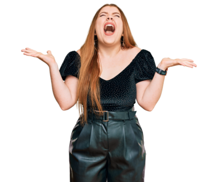 Young beautiful redhead woman wearing elegant clothes celebrating mad and crazy for success with arms raised and closed eyes screaming excited. winner concept