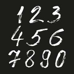 Set of calligraphic numbers painted by white brush on isolated black background. Lettering for your design. Vector illustration.