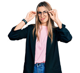 Hispanic young woman wearing elegant jacket and glasses clueless and confused expression. doubt...