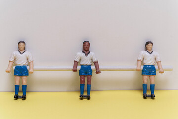 Three figurines of people,football players. mini football team, teamwork, sports