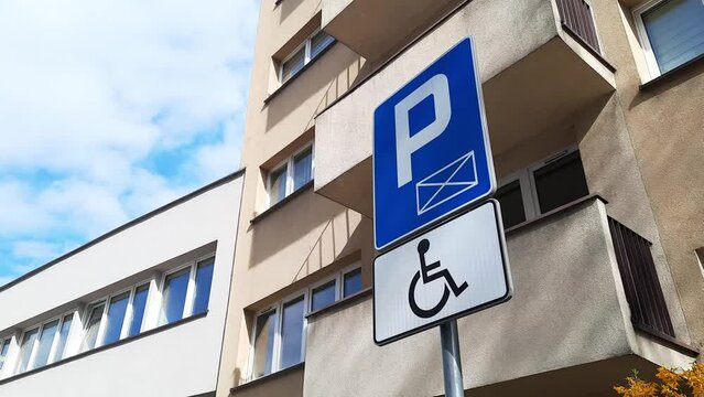 Road sign Disabled Parking against backdrop of apartment building in residential area. Concept of Accessible Parking and  locations. Adapted spaces for people with disabilities. Inclusion