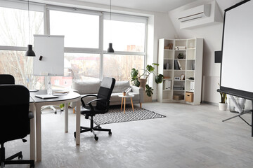 Interior of stylish conference hall with table, sofa and armchairs