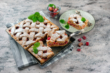Traditional rhubarb sheet cake with spelt flour served as close-up on a Nordic Design plate