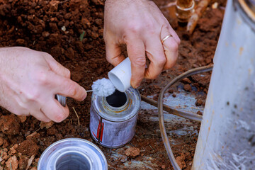 Plumbers use clear primer for PVC pipes before gluing them before completing repair work