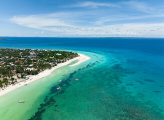 Flying over a beautiful sandy beach and a blue ocean. Bantayan island, Philippines.