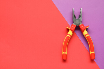 Combination pliers on color background, top view. Space for text