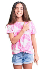 Cute hispanic child girl wearing casual clothes cheerful with a smile of face pointing with hand and finger up to the side with happy and natural expression on face
