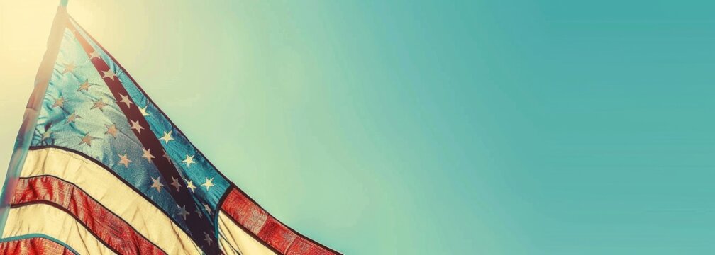 Vintage American flag waving in the wind on a clear sky background with copy space, in the style of a 4th of July design element Generative AI