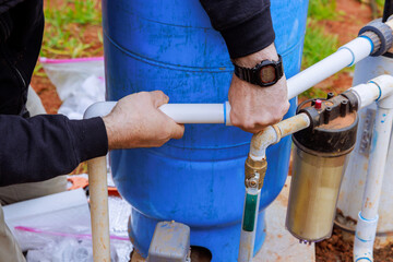 Plumber connects water to well pump for new house