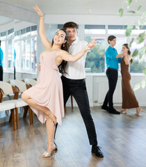 Guy is professional dancer and teacher focused on his female partner, teaching her to perform...