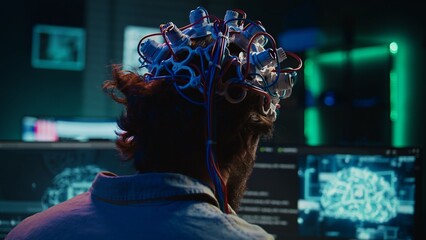 Engineer puts EEG headset on, links brain to cyberspace, conducts experiments. Man merging mind...