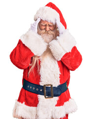 Old senior man with grey hair and long beard wearing traditional santa claus costume with hand on head, headache because stress. suffering migraine.