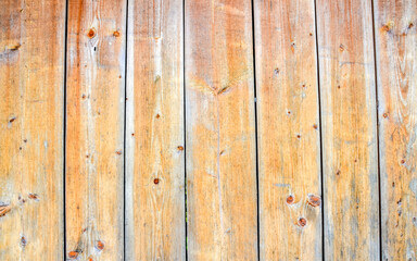 Close-up view of vertical boards of a weathered wooden wall. Perfect for backgrounds, textures, or design projects, this image captures the timeless charm of aged wooden planks