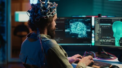 Computer scientist researching brain machine transferring, conducting experiments to achieve...