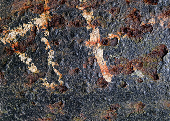 Rusted metal with black paint and partial letters