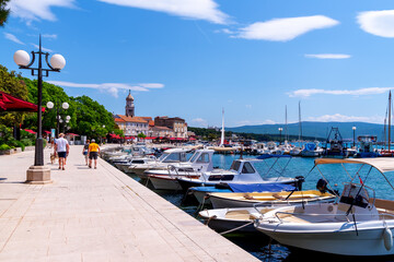 Boats in the harbour with crystal-clear turquoise water on the island of Krk, Croatia