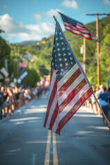 American flag waving in focus with blurred parade background, symbolizing national pride.