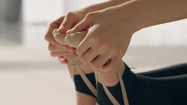 Close up feet girl child kid athlete dancer ballerina female flexible gymnast stretching legs gymnastic exercise on floor flexibility stretch foot fingers ballet school dance class rhythmic gymnastics
