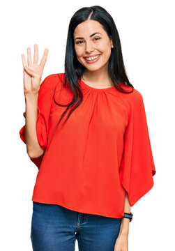 Beautiful young woman wearing casual clothes showing and pointing up with fingers number four while smiling confident and happy.