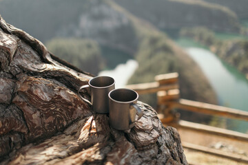 Camping mugs on the wood at canyon viewpoint