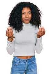 Young african american girl wearing casual clothes doing money gesture with hands, asking for...