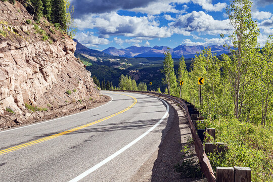 Winding asphalt road of Colorado's Million dollar Highway, US Route 550 and summer mountain landscape
