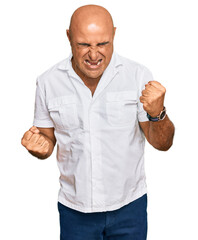 Mature middle east man with mustache wearing casual white shirt celebrating surprised and amazed for success with arms raised and eyes closed. winner concept.