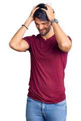Fototapeta premium Handsome hispanic man wearing casual clothes suffering from headache desperate and stressed because pain and migraine. hands on head.