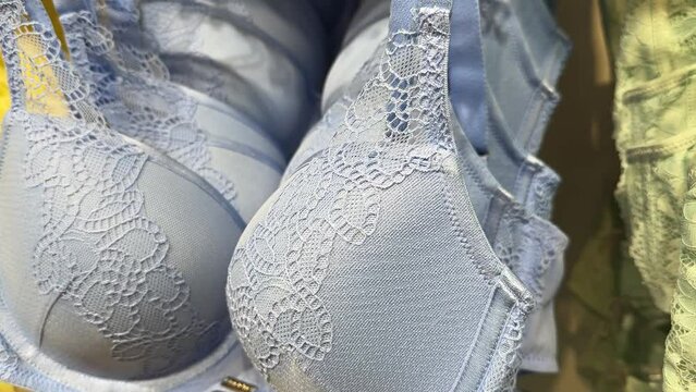 Bright stylish female underwear. Showcase with new lingerie at the boutique. Close-up of brassiere