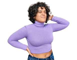 Young hispanic woman with curly hair wearing casual clothes suffering of neck ache injury, touching neck with hand, muscular pain