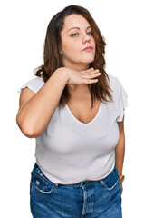 Young plus size woman wearing casual white t shirt cutting throat with hand as knife, threaten aggression with furious violence