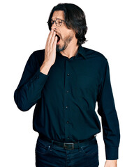 Middle age caucasian man wearing casual clothes and glasses bored yawning tired covering mouth with...