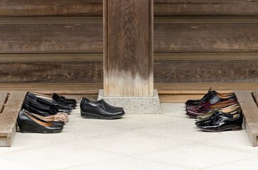 A row of shoes are lined up on a wooden platform
