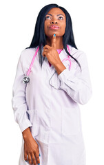Young african american woman wearing doctor stethoscope thinking concentrated about doubt with...
