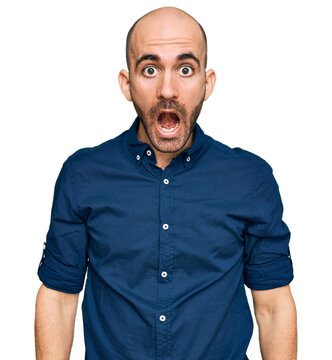 Young hispanic man wearing casual clothes afraid and shocked with surprise and amazed expression, fear and excited face.