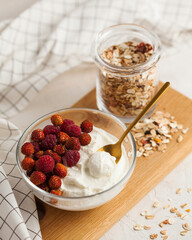 Soft farmer's cottage cheese with strawberries, a rustic and wholesome dairy delight.