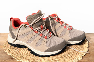 pair brown comfortable New trekking sneakers, beige waterproof hiking boots with laces on...