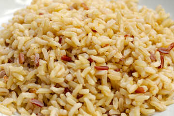 Cooked brown rice in white bowl