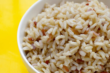 Cooked brown rice in white bowl