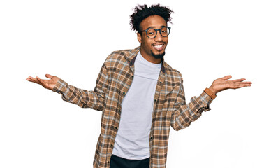 Young african american man with beard wearing casual clothes and glasses smiling showing both hands open palms, presenting and advertising comparison and balance