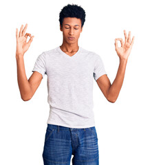 Young african american man wearing casual white t shirt relax and smiling with eyes closed doing meditation gesture with fingers. yoga concept.